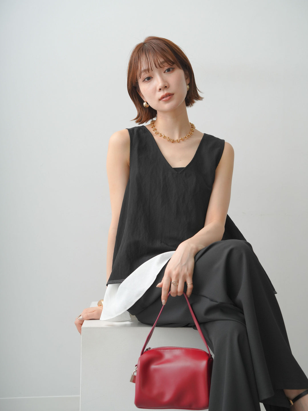 [予約]アシメフリルドッキングステッチノースリブラウス/black