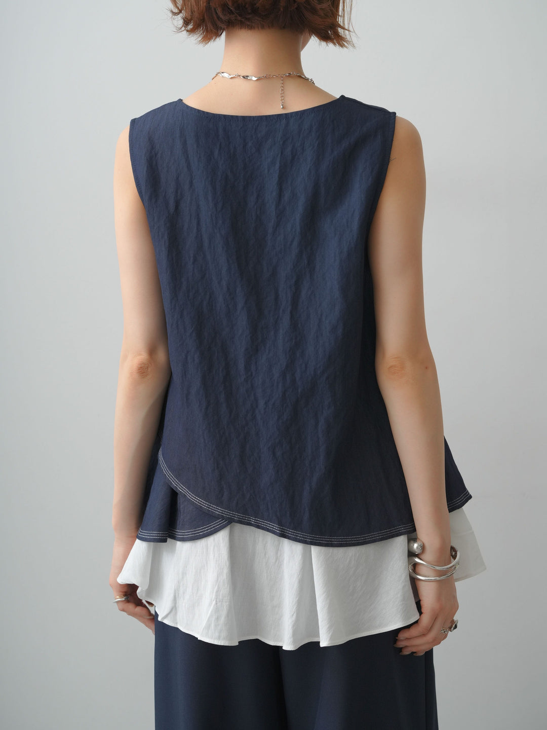 [予約]アシメフリルドッキングステッチノースリブラウス/navy